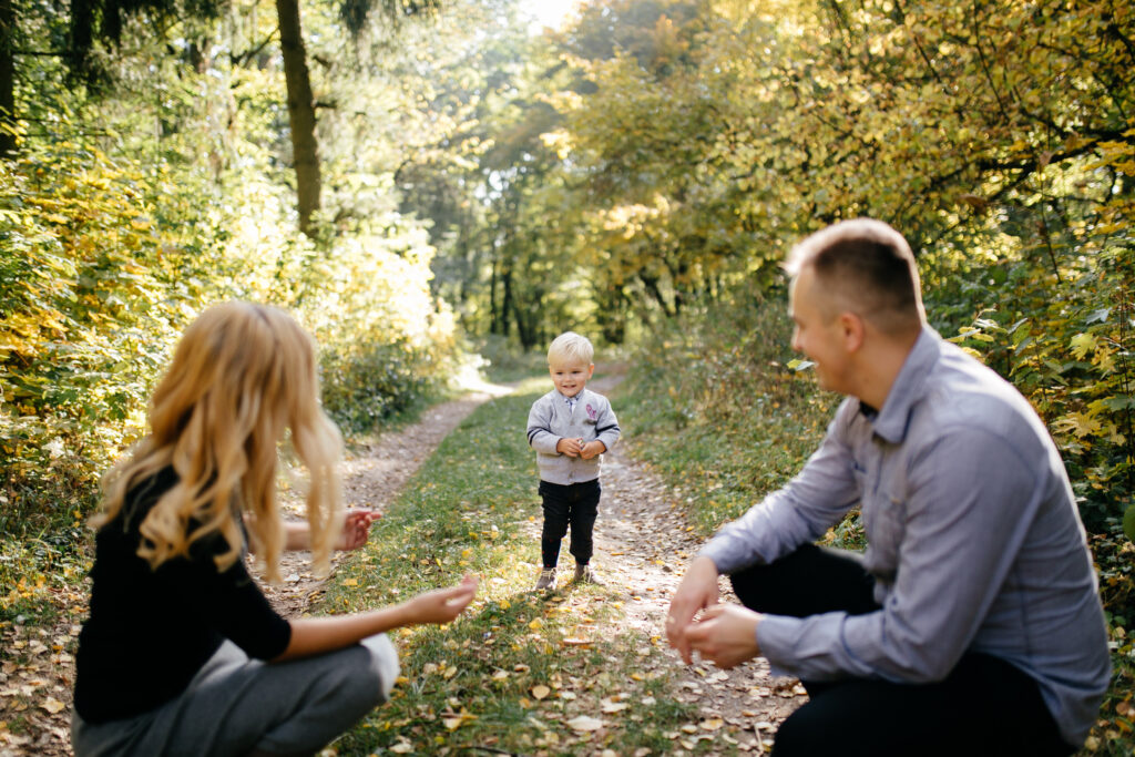 happy family playing and laughing in autumn park